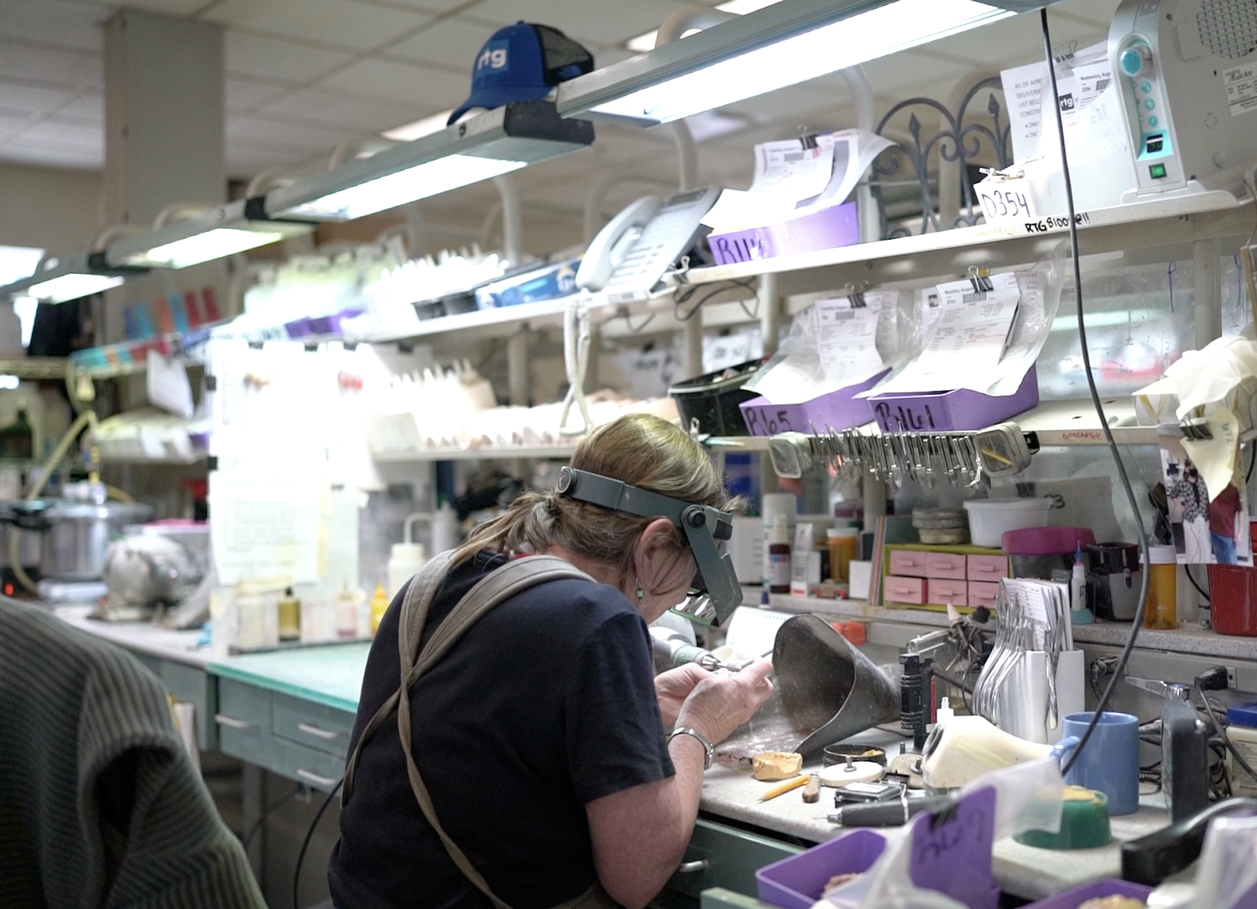 Technician working on bench in a dental lab.