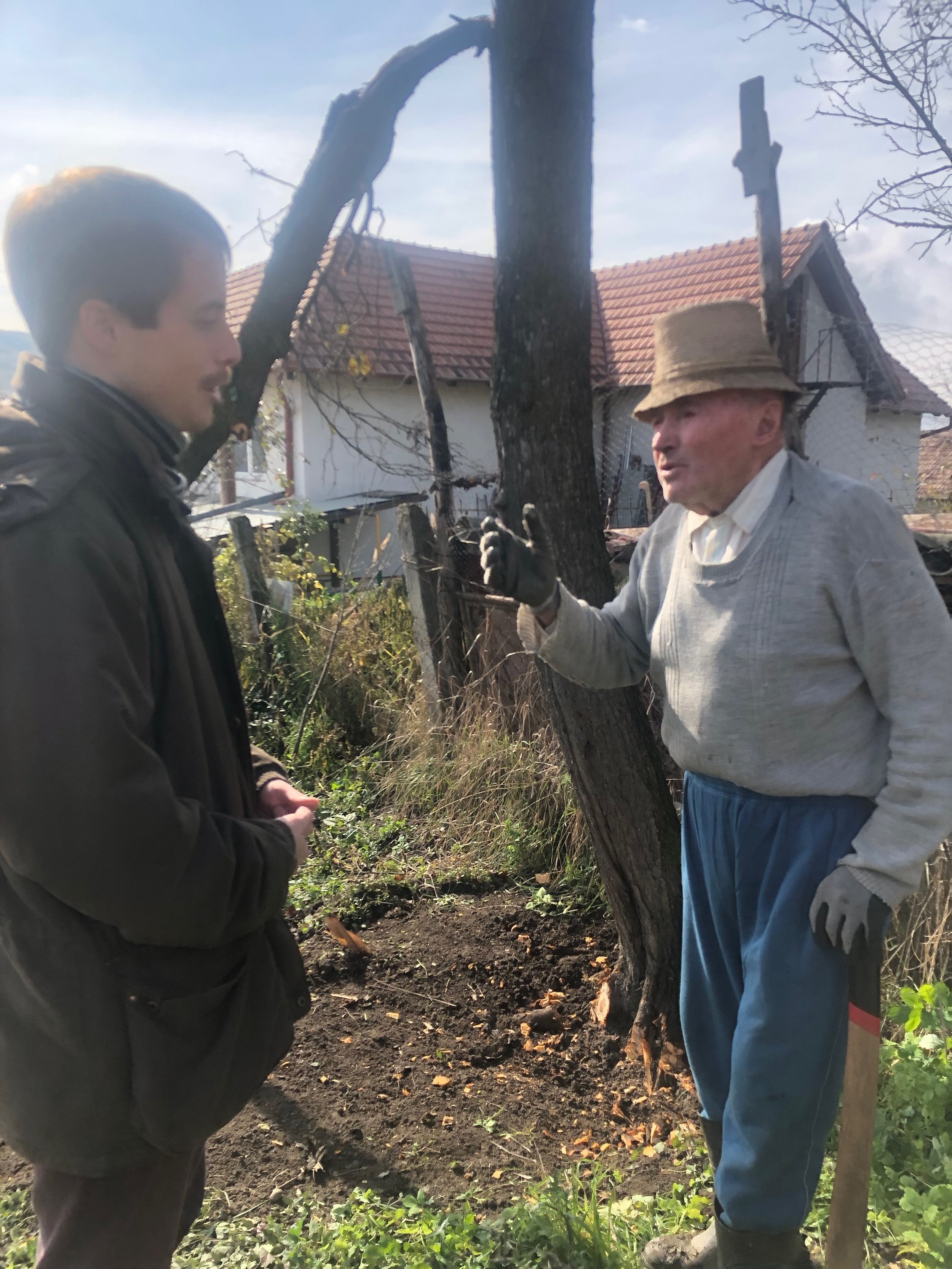  Talking to Pista bácsi after finding him chopping down a tree 
