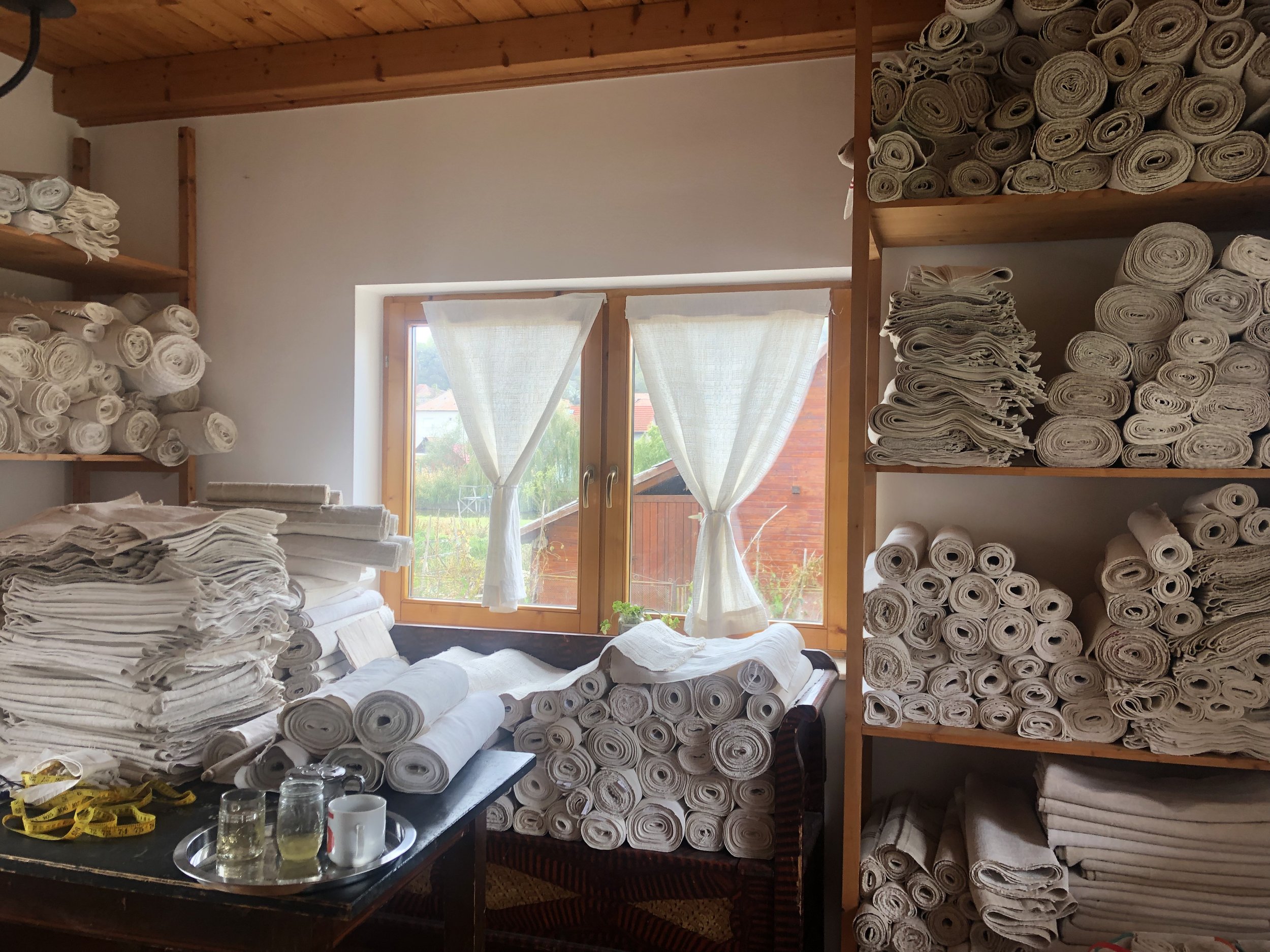  Zsuzsi and Cara run a business exporting textiles! These are handmade rolls of fabric that were woven decades ago.  