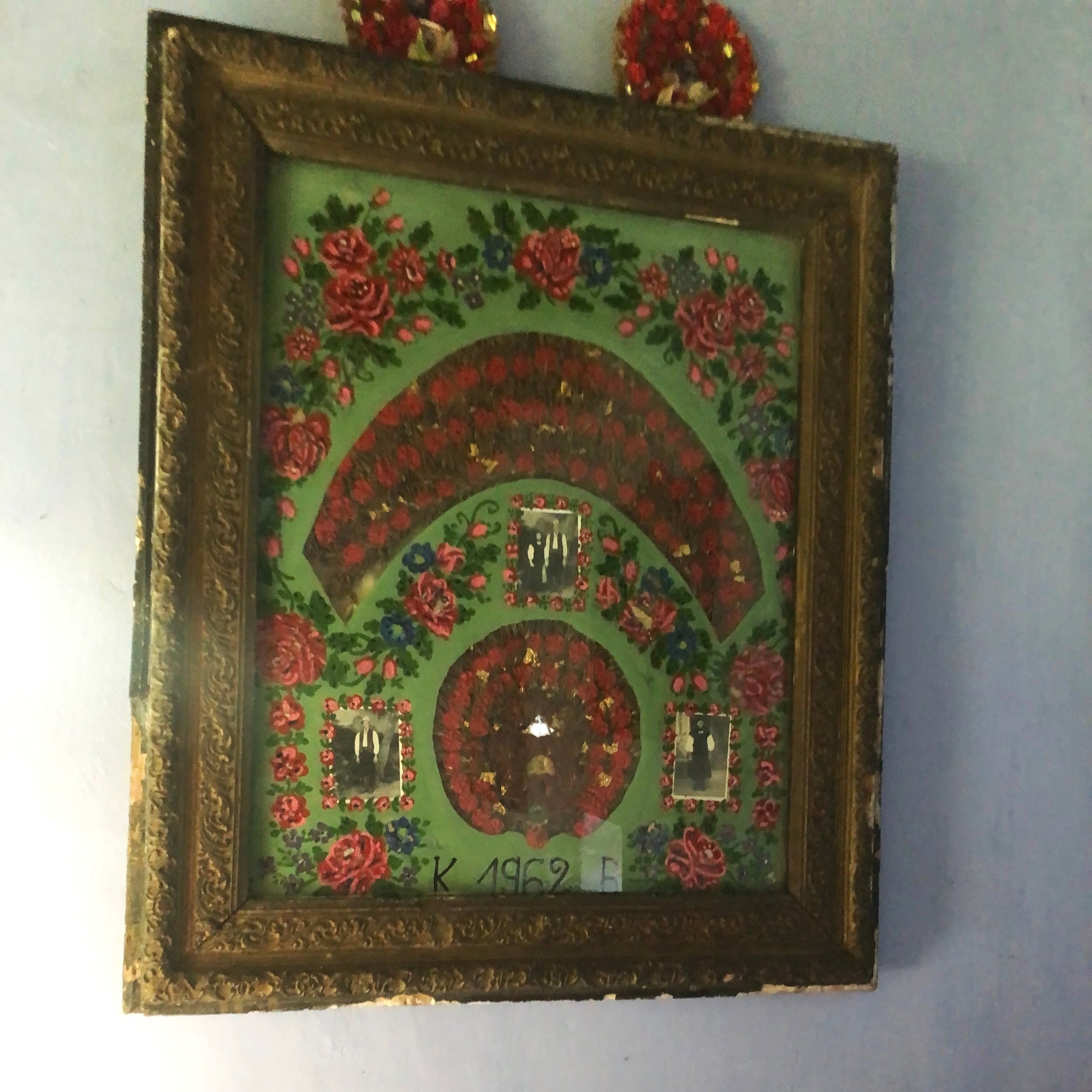  This piece, made by Zsuzsi’s grandmother, displays the traditional Széki wedding headdress, which was made out of rosemary, along with wedding photos.  