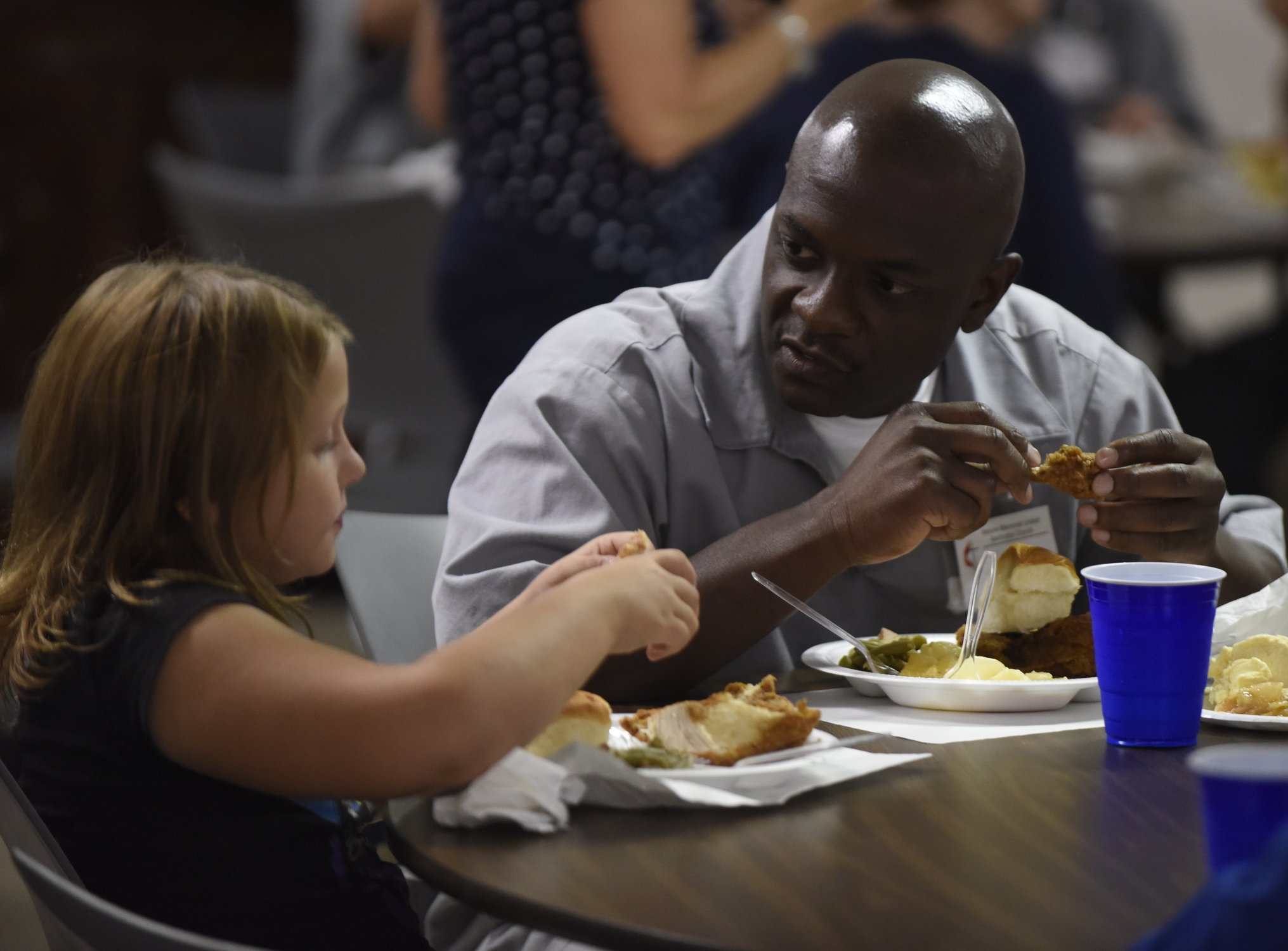  Alyson Taylor, 8, left, converses with Raymond Wilson after a service on Sunday at the Nelson Memorial United Methodist Church. Wilson, an inmate at the Boonville Correctional Center, participated in a weeklong service project that concluded after t