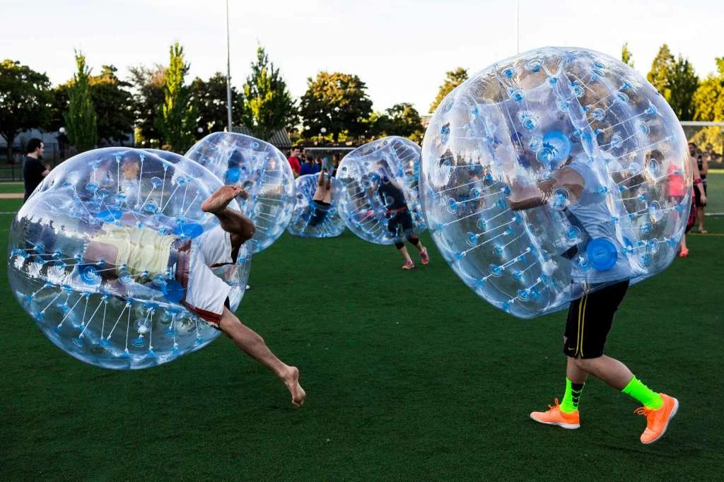Before the first match, players tested out the "crash-ability" of their bouncy, blue orbs during Seattle's first "Bubble Futbol" - or soccer - tournament Sunday, September 7, 2014, at Cal Anderson Park in Capitol Hill in Seattle, Washington. The unlikely sport originated in Europe and is quickly sweeping the U.S., with a recent spotlight on The Tonight Show with Jimmy Fallon. The event was put on by Seattle-local nonprofit "The World is Fun" as a celebration of the organization's fifth anniversary. Photo: JORDAN STEAD, SEATTLEPI.COM
