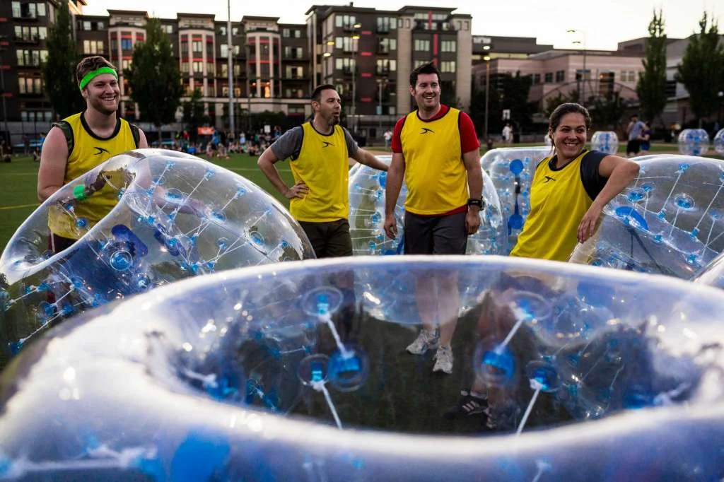 Teams come together following a match at Seattle's first "Bubble Futbol" - or soccer - tournament Sunday, September 7, 2014, at Cal Anderson Park in Capitol Hill in Seattle, Washington. The unlikely sport originated in Europe and is quickly sweeping the U.S., with a recent spotlight on The Tonight Show with Jimmy Fallon. The event was put on by Seattle-local nonprofit "The World is Fun" as a celebration of the organization's fifth anniversary. Photo: JORDAN STEAD, SEATTLEPI.COM