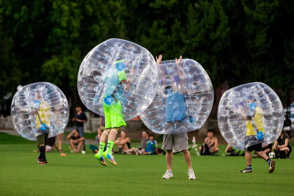 Orbed players fail at a high five attempt during Seattle's first "Bubble Futbol" - or soccer - tournament Sunday, September 7, 2014, at Cal Anderson Park in Capitol Hill in Seattle, Washington. The unlikely sport originated in Europe and is quickly sweeping the U.S., with a recent spotlight on The Tonight Show with Jimmy Fallon. The event was put on by Seattle-local nonprofit "The World is Fun" as a celebration of the organization's fifth anniversary. Photo: JORDAN STEAD, SEATTLEPI.COM