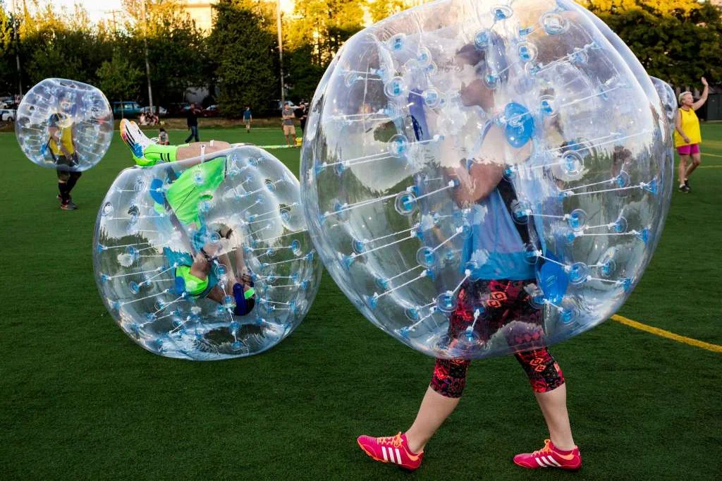 Before the first match, players tested out the "crash-ability" of their bouncy, blue orbs during Seattle's first "Bubble Futbol" - or soccer - tournament Sunday, September 7, 2014, at Cal Anderson Park in Capitol Hill in Seattle, Washington. The unlikely sport originated in Europe and is quickly sweeping the U.S., with a recent spotlight on The Tonight Show with Jimmy Fallon. The event was put on by Seattle-local nonprofit "The World is Fun" as a celebration of the organization's fifth anniversary. Photo: JORDAN STEAD, SEATTLEPI.COM