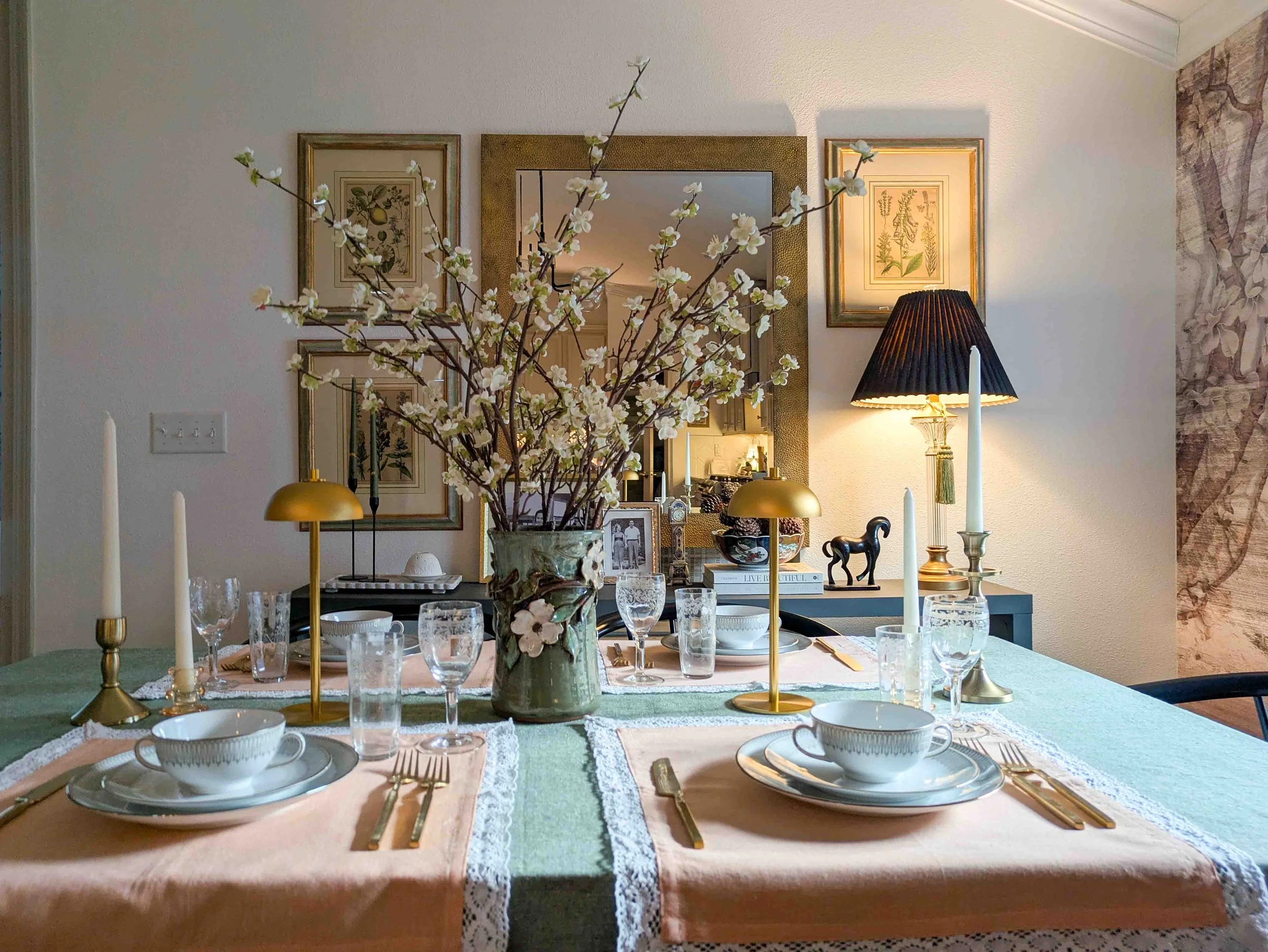 A table set for Valentine's day using light green and peach colors.