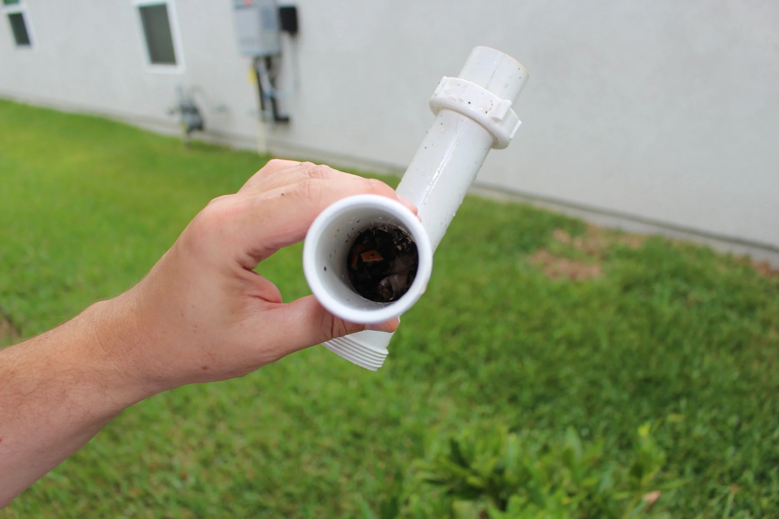 clearing out debris from garbage disposal pipes