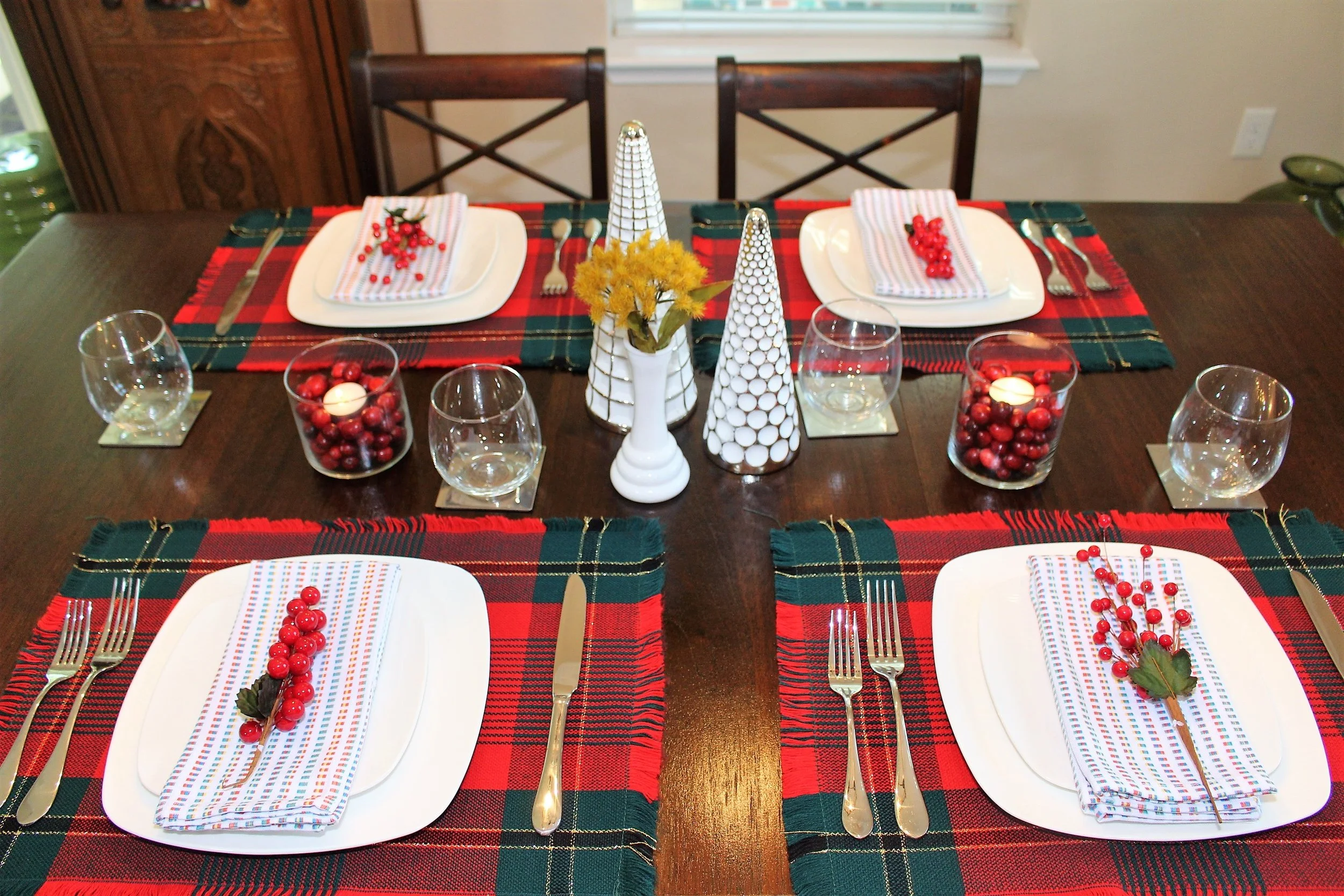 My favorite thus far, decorating our dining table for Christmas! I filled two old candle jars with cranberries and placed a tea candle on top. It makes a simple table decor come together!
