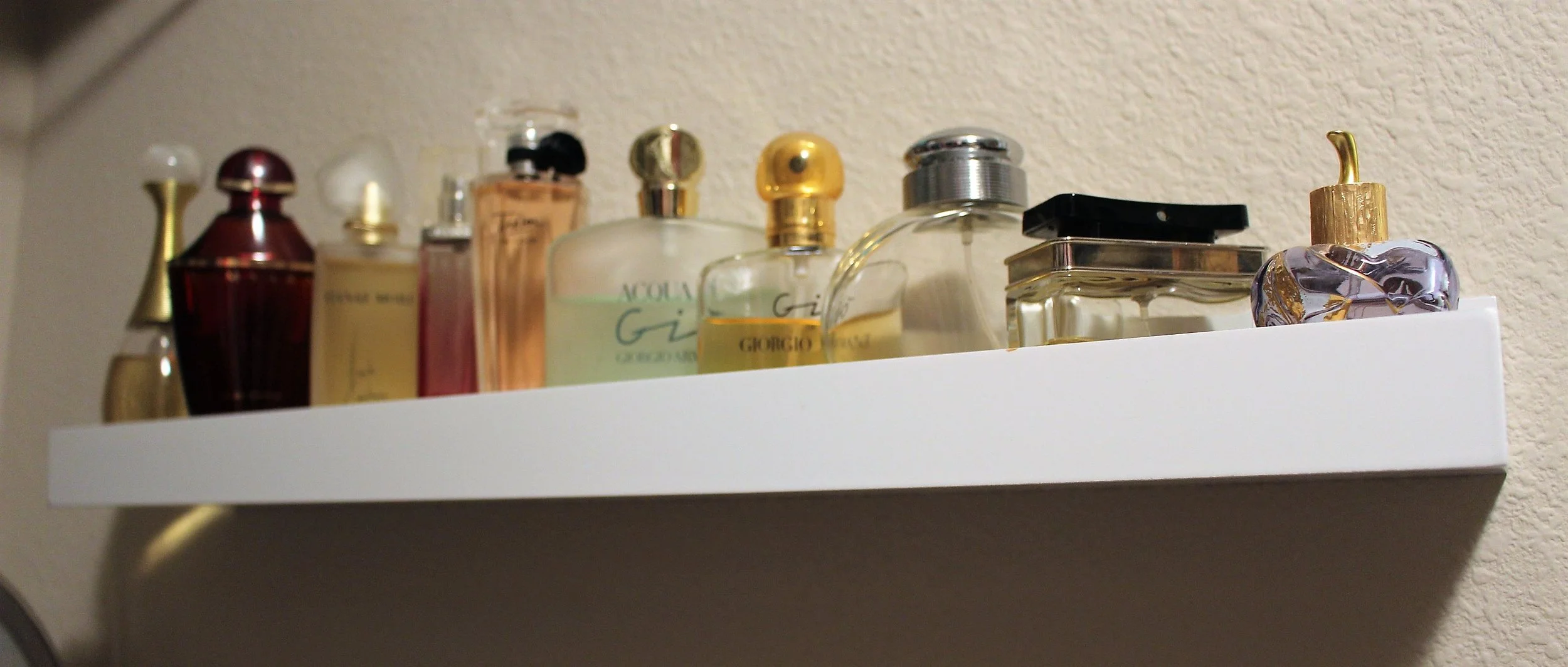I found that picture ledges help keep perfume bottles nicely and out of the way.