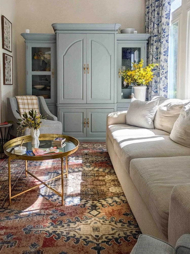 A sunny, bright room with a big French blue cabinets.