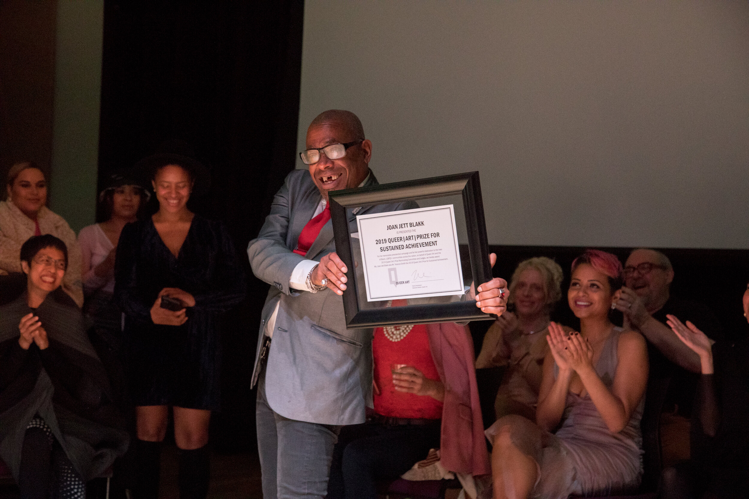 Terence Smith aka Joan Jett Blakk posing with their Sustained Achievement Award (photo by Cayetana Suzuki)