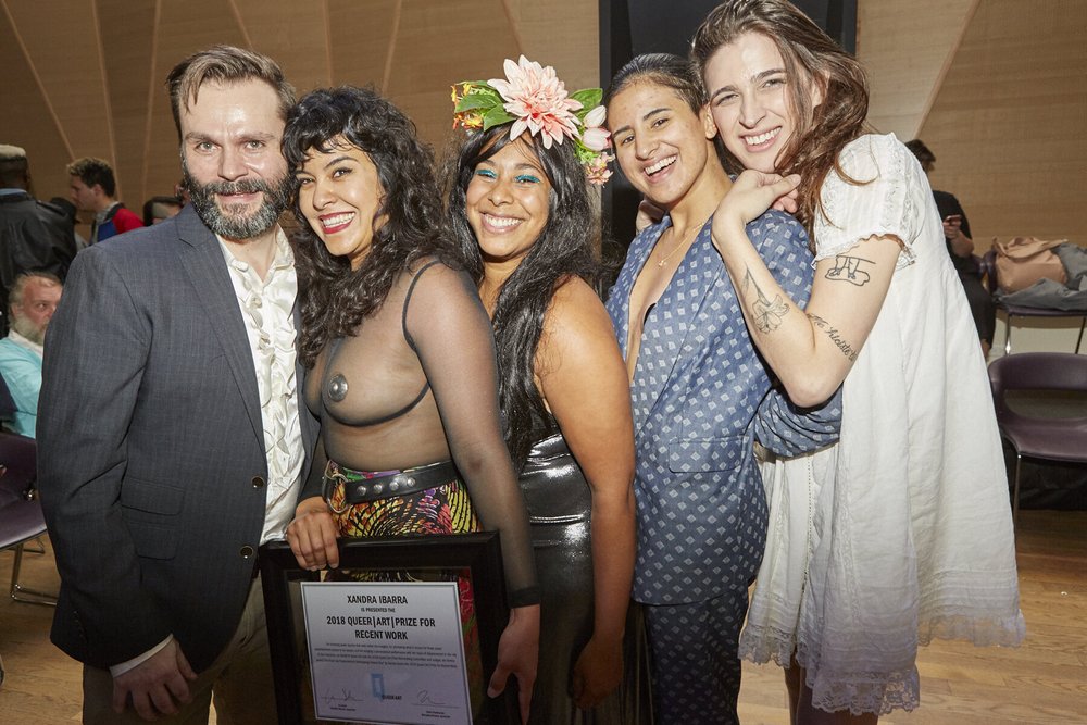  2018 Queer|Art|Prize Recent Work winner Xandra Ibarra (2nd from left) with presenter Vivian Crockett (3rd from left) and Queer|Art Staff (Travis Chamberlain, KT Pe Benito, and Rio Sofia, from left to right) at the 2018 Annual Party. Image by Eric Mc