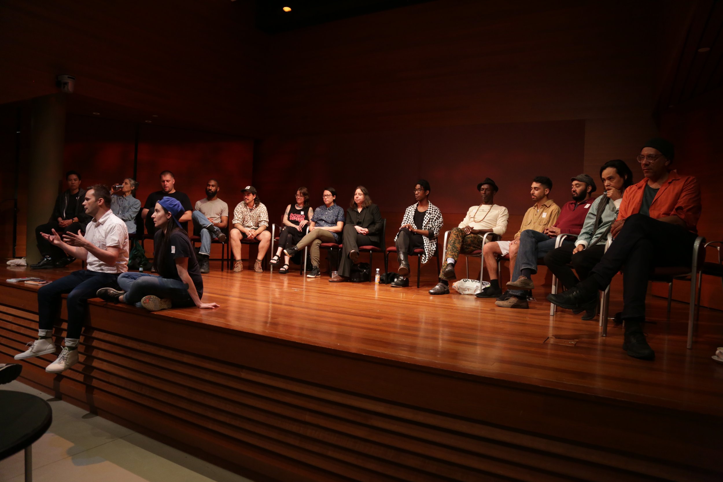  Travis Chamberlain and various QAM Mentors speaking at the Rubin Museum. 