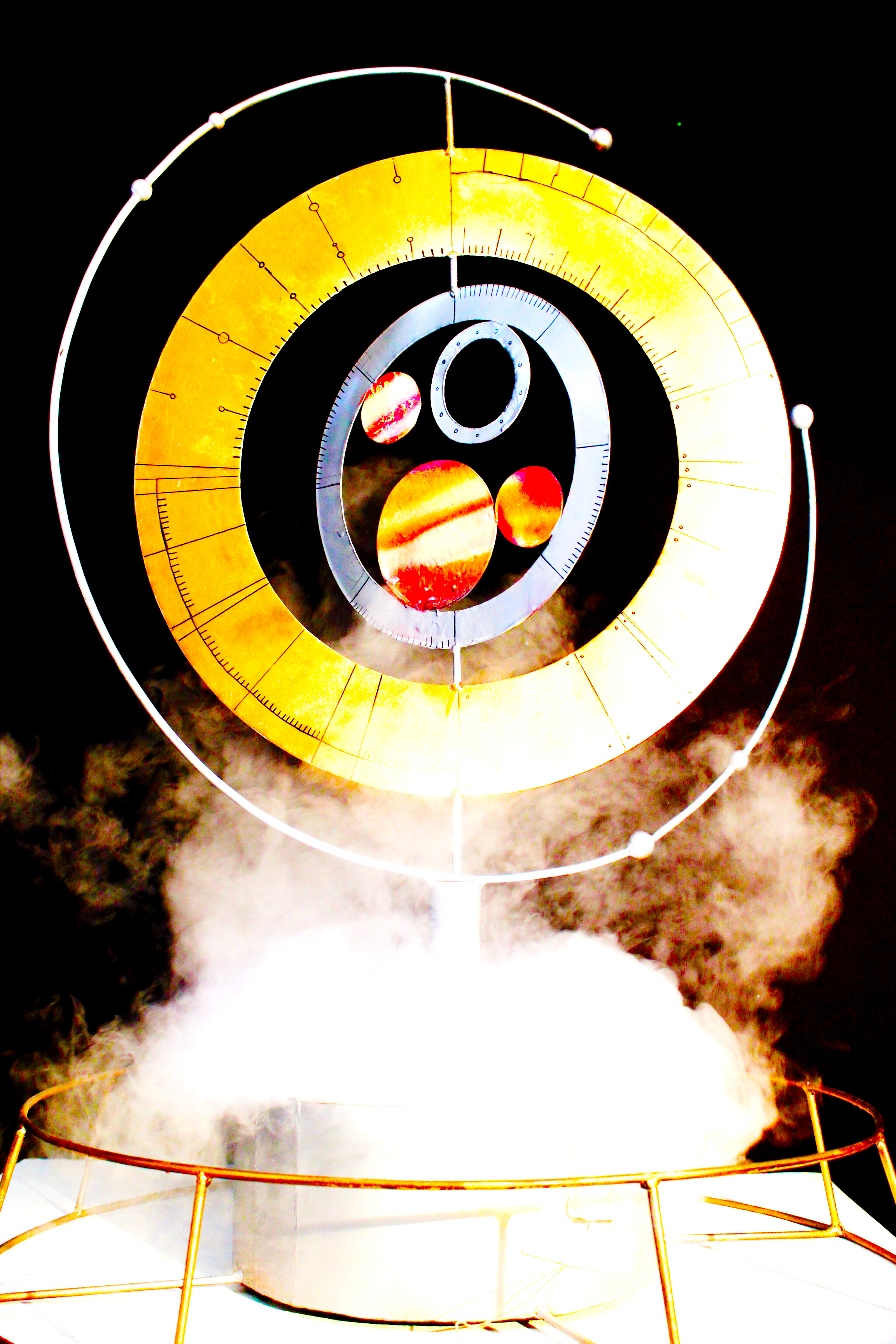 Metallic sculpture, spray paint, LED lights, and fog