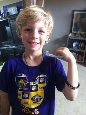 This is Davis, the first costumer of Live at the Cross. He is proudly showing off his necklace and rubber bracelet.April 2, 2014