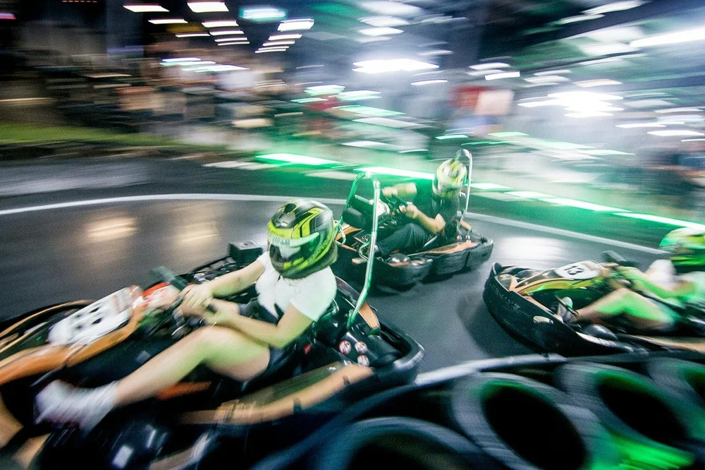 Go karts racing under lights at a Gold Coast indoor karting track