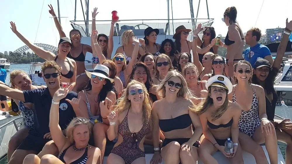 Group celebrating together on the deck of a Sydney Harbour party boat charter