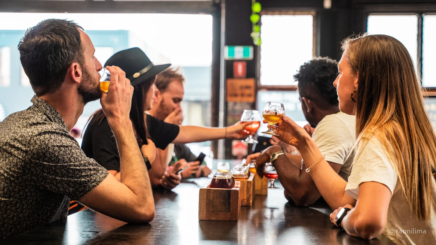 Friends cheersing on a build-your-own Inner West brewery and distillery tour
