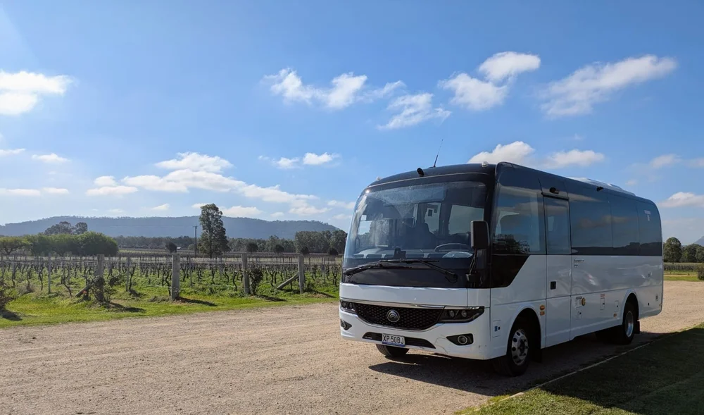 The Urban Legends 27-seater coach at a Hunter Valley vineyard below the escarpment