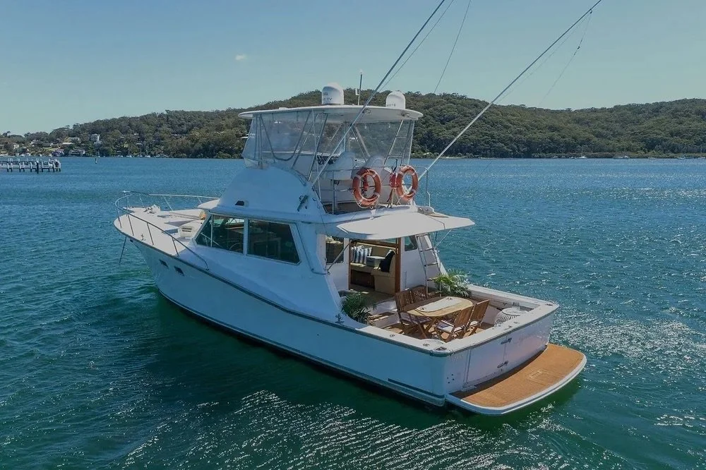 Flybridge power boat cruising Sydney Harbour on a private yacht charter