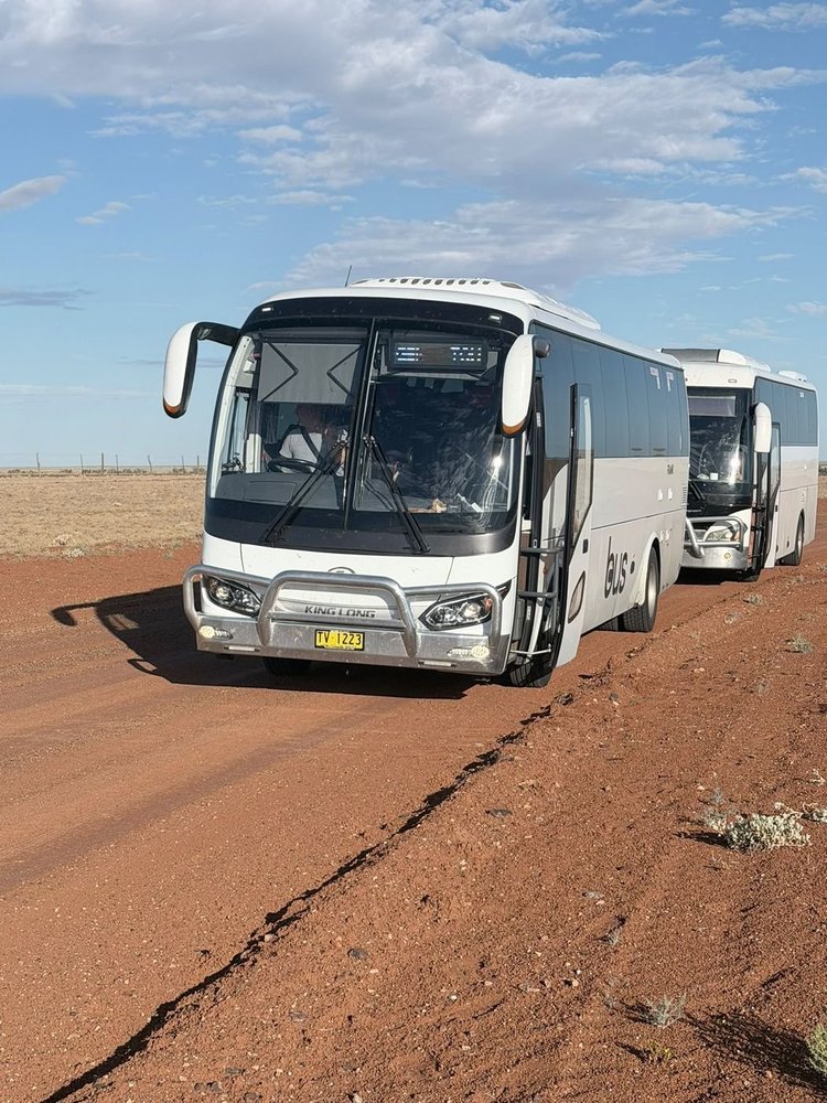 Urban Legends King Long luxury coach leading a two-coach convoy on an outback red dirt road