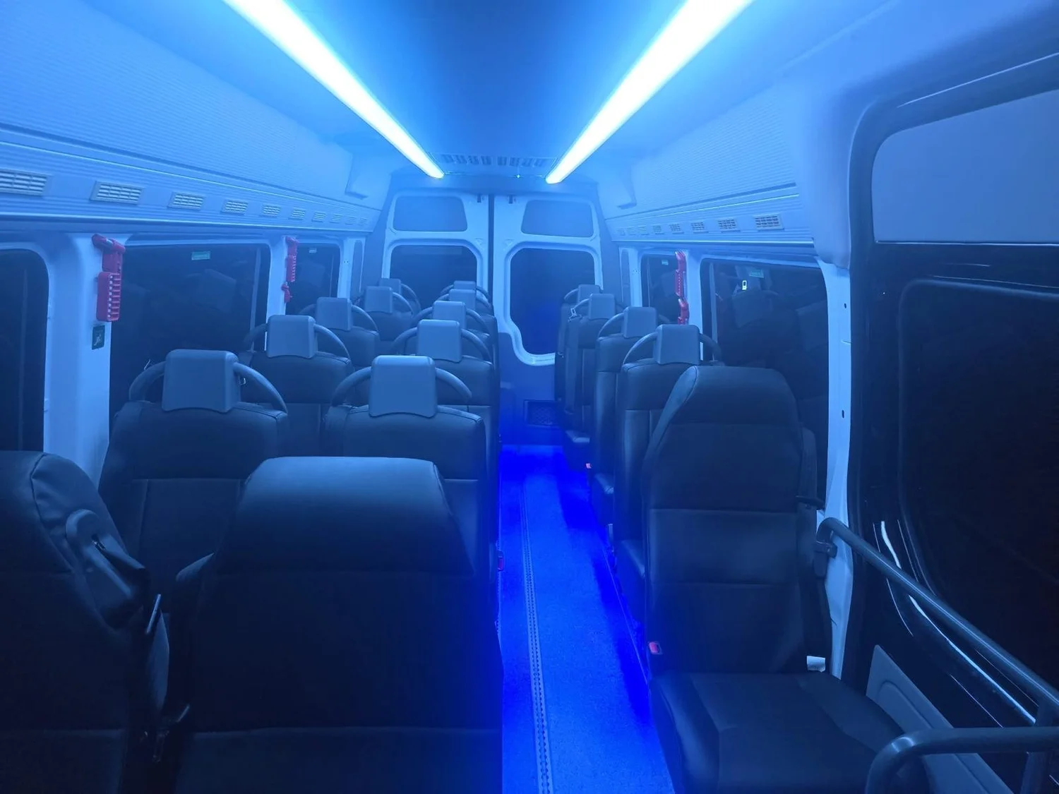 Inside an Urban Legends coach, comfortable seating with USB and climate control for a team
