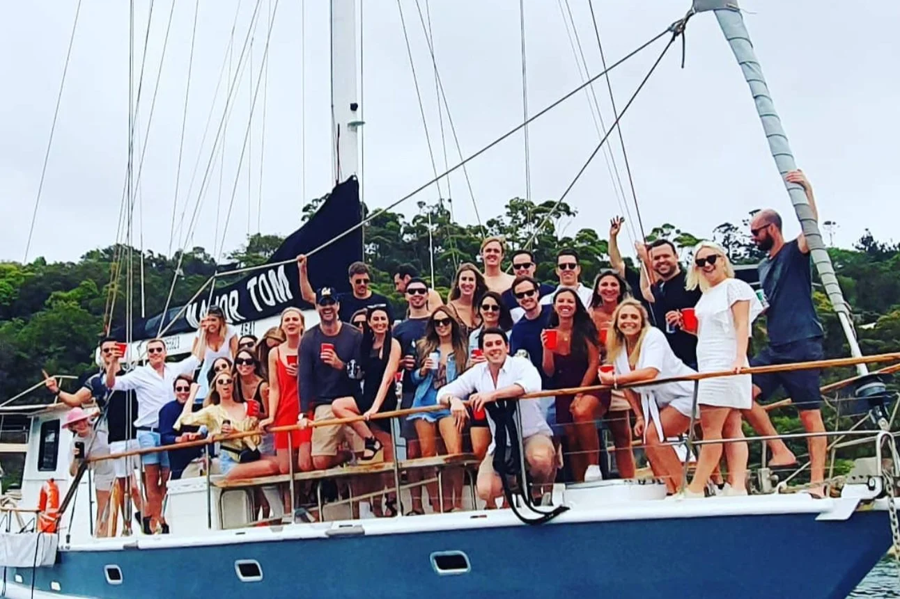 Corporate team on the deck of a sailing yacht during a Sydney Harbour team building regatta