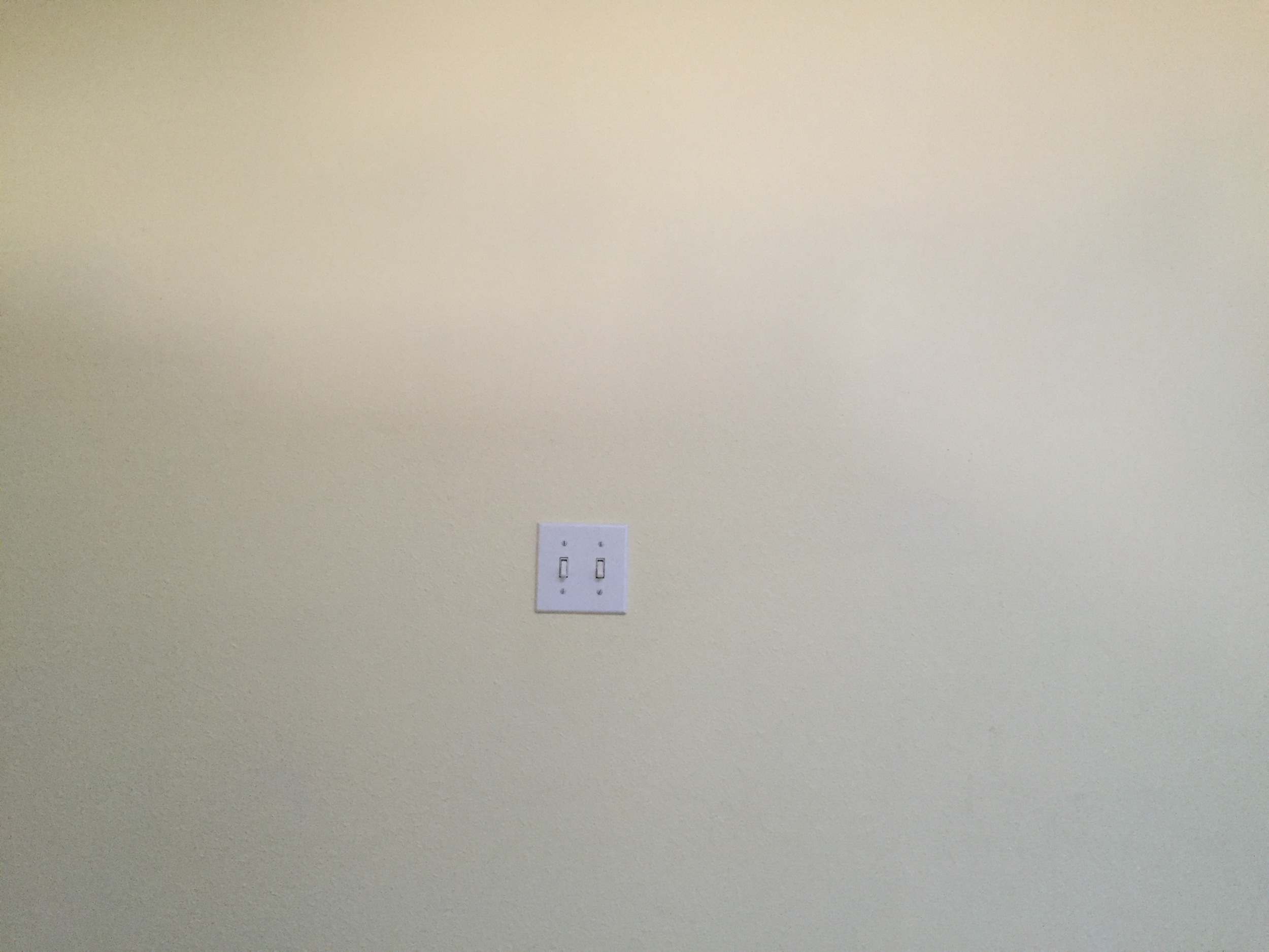 I'd hung different pieces of framed art here, but being such a big space, it never looked quite right.