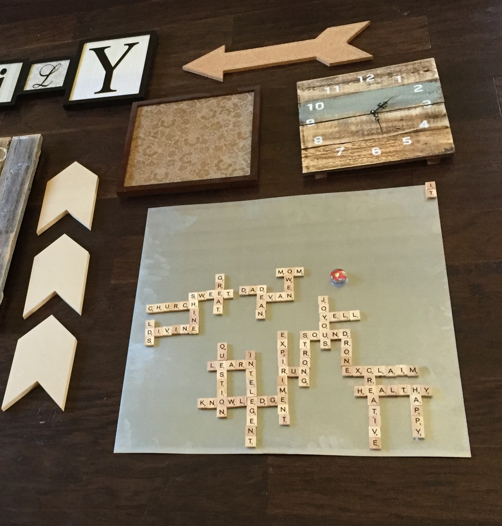 The boys had been sneaking words onto the scrabble board for the past week. There might be some creative spelling happening here, but they're having fun with it.