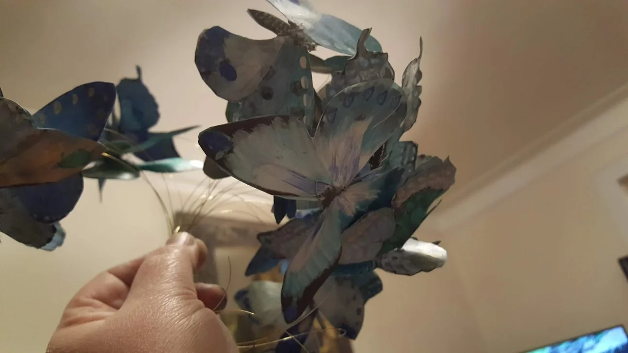 MANY OF THE BUTTERFLY'S WERE WIRED TO HANG FROM THE CEILING AND CATCH THE AIR FOR THE ILLUSION OF FLYING