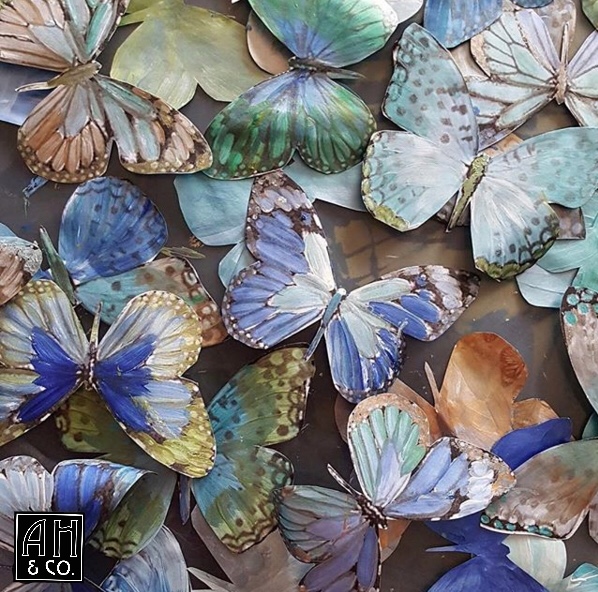Detail photo of the butterflies being created with custom blended shimmer paint- replicating the true natural iridescence of their wings.
