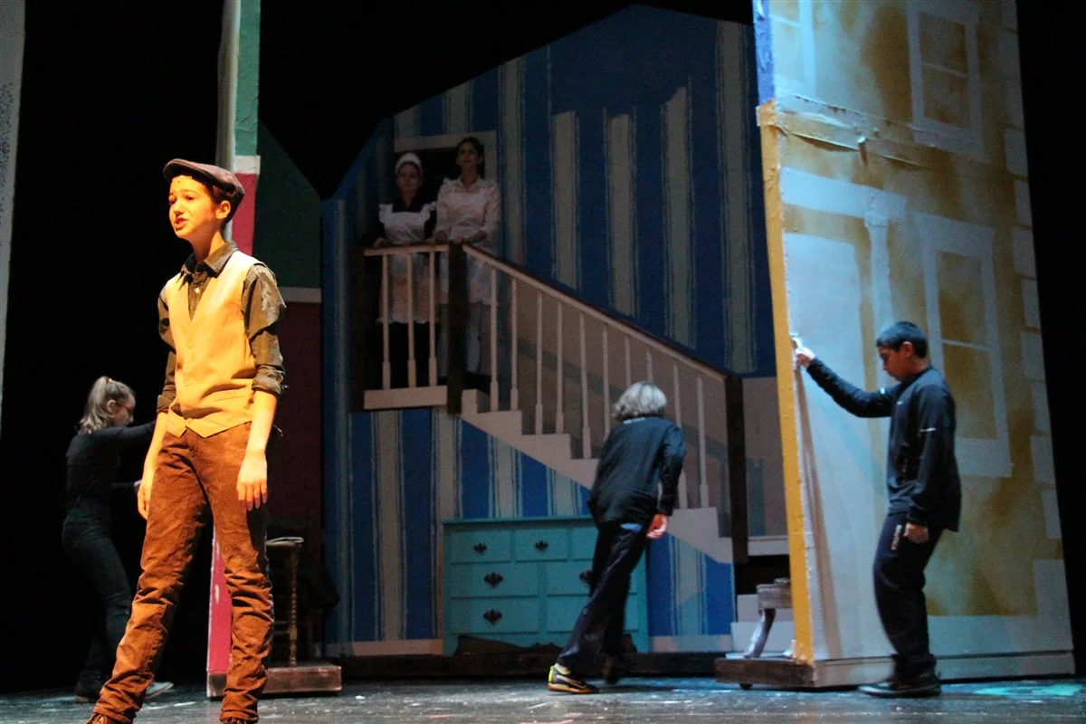 The stage crew practices opening the house. Blink and you'll miss it.