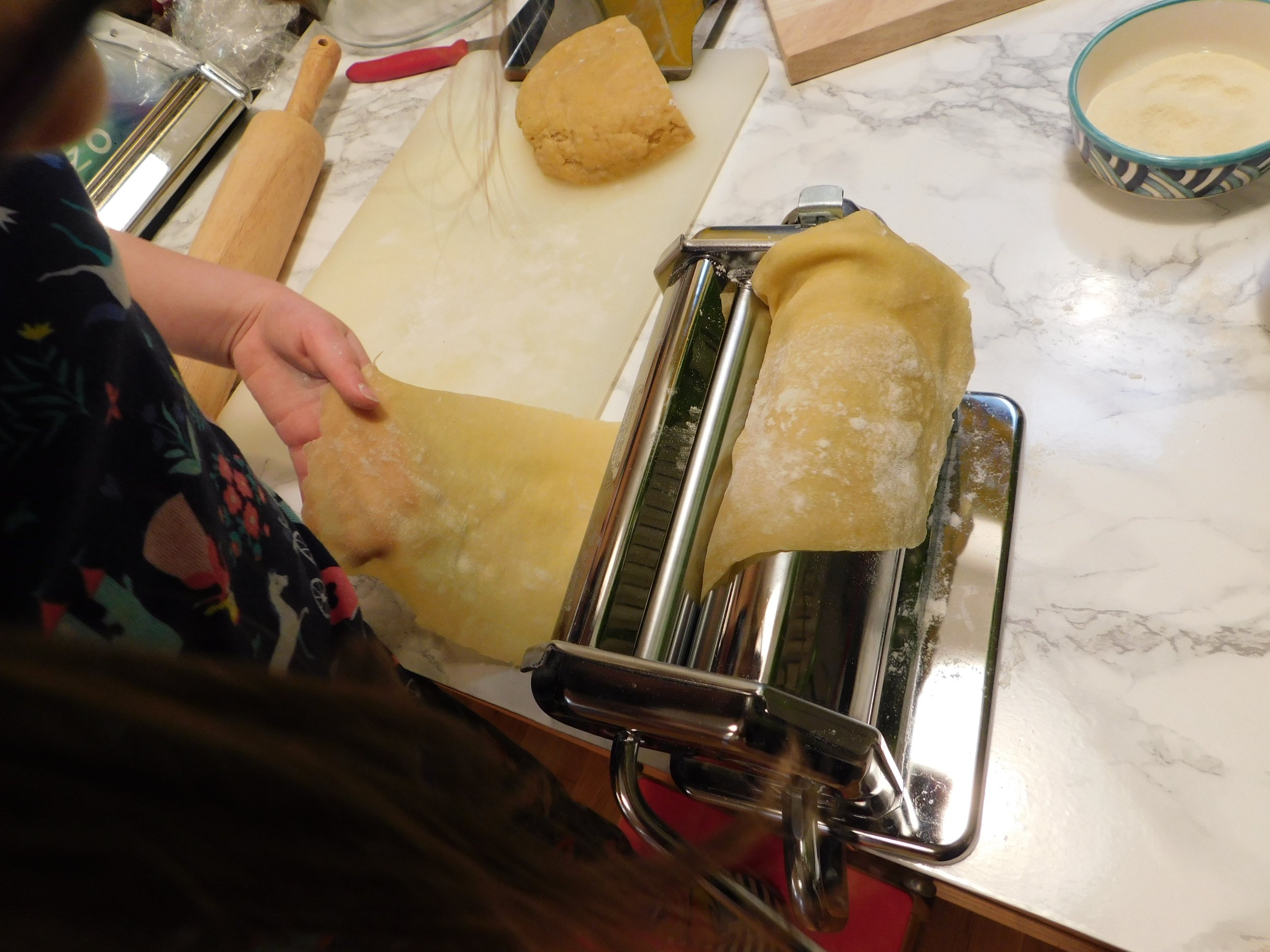 passing dough in pasta machine