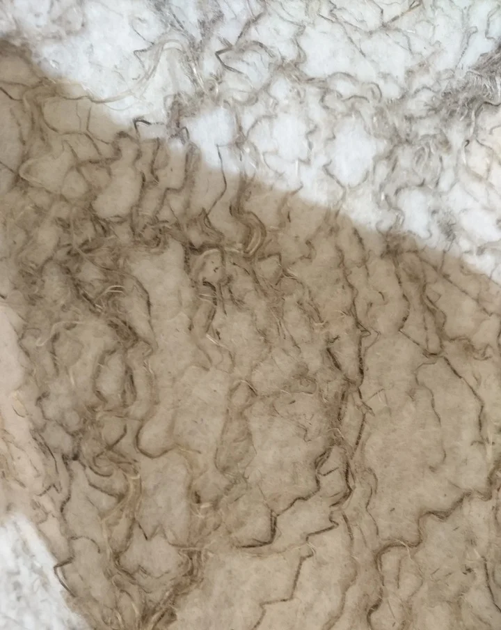 Visited a felt maker's studio in Merano, a city about an hour away from the farm. A close up of a blanket that mixes hemp fiber to create a flecked texture.