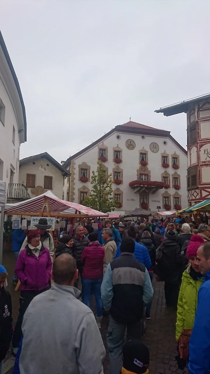 Walking through a market that sold local wine, produce, roasted chestnuts, pastries, farming equipment, etc.
