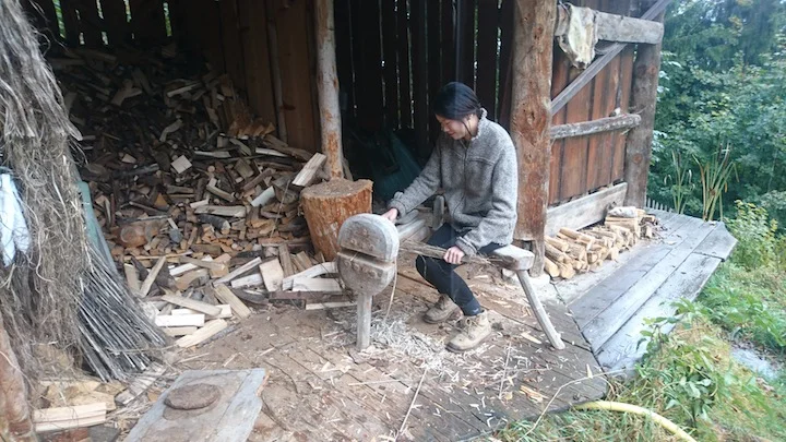 Learning how to use a wooden tool that splits the hemp stalk from the fiber.