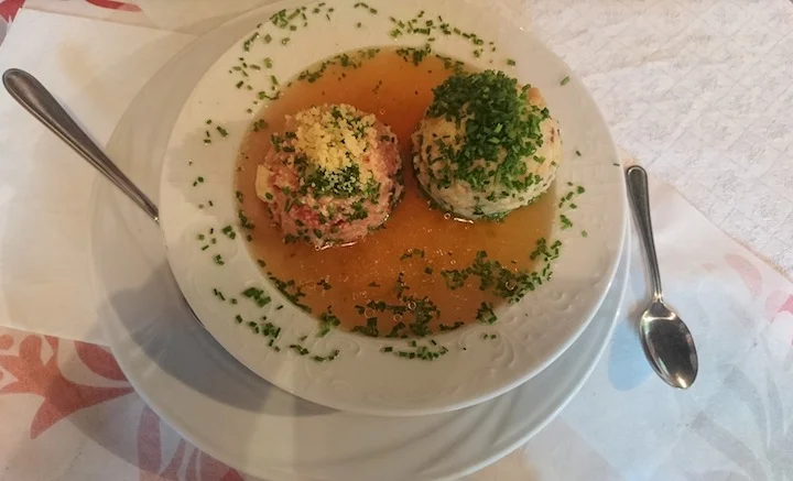 Knödelsuppe - The most delicious meal here. One of the "knödel" was filled with beets which is why the broth is red.