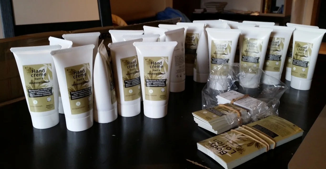 Putting labels on hemp lotion bottles to be sold at local markets.