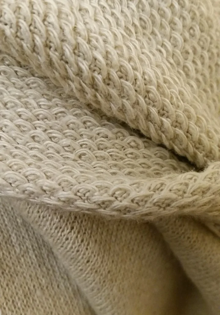 Closeup of 100% hemp knit-like fabric -- face and reverse side.