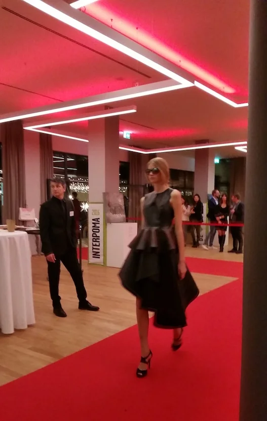 Fashion designer Mateja Benedetti showcasing her work at Interpoma. The leather-like fabric she uses was created from the by-product of apple skins.