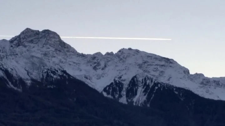 An airplane passes over the glaciers of the Ortler mountains where the Laas marble is mined.