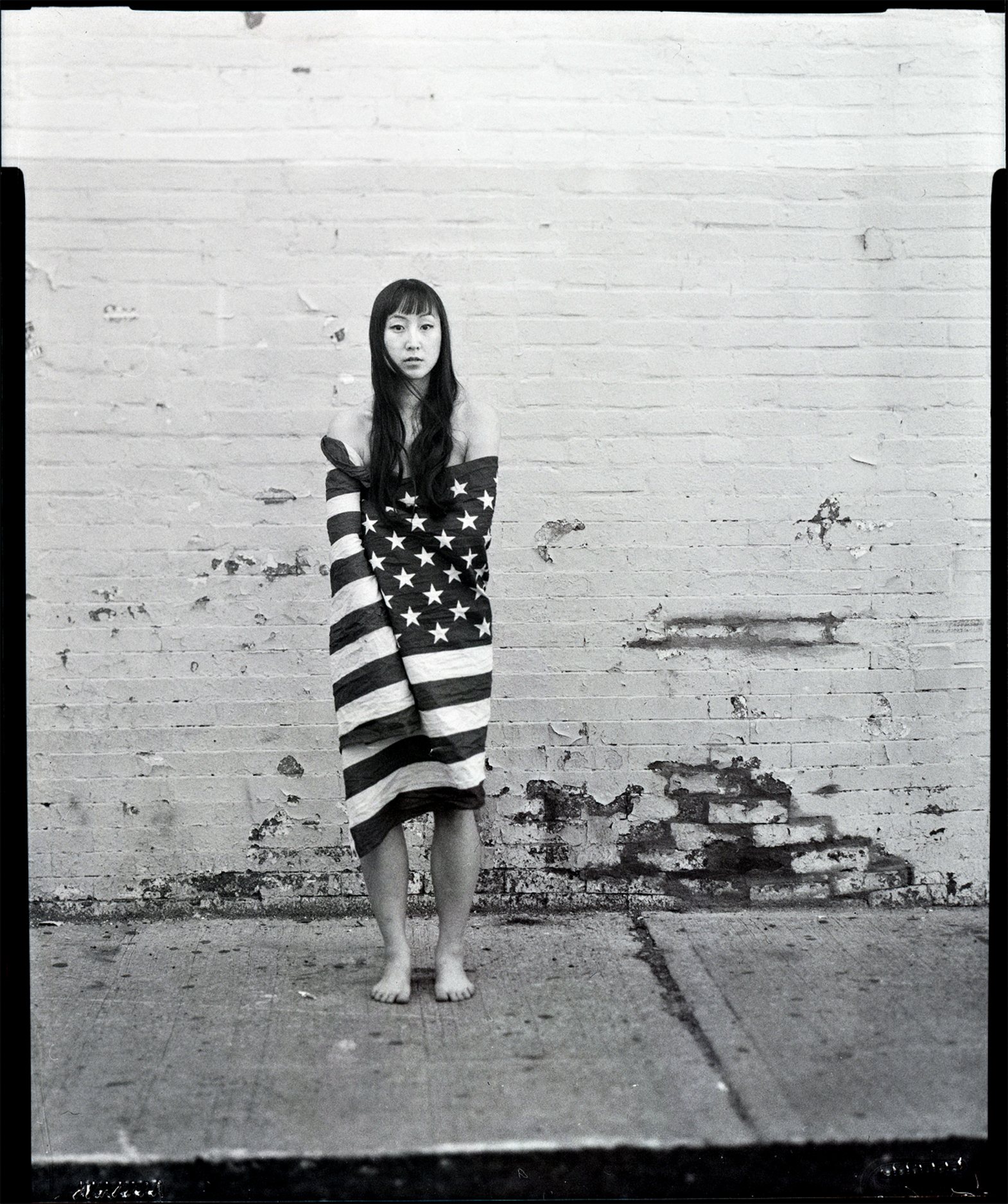 "As an American woman with Vietnamese heritage, I was interested in showing myself in a pose normally construed as vulnerable - appearing nude under the flag of the country that is supposed to be my protector. The idea of this was to diminish the o