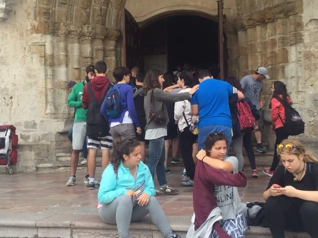 Bored students on tour of Llanes Cathedral