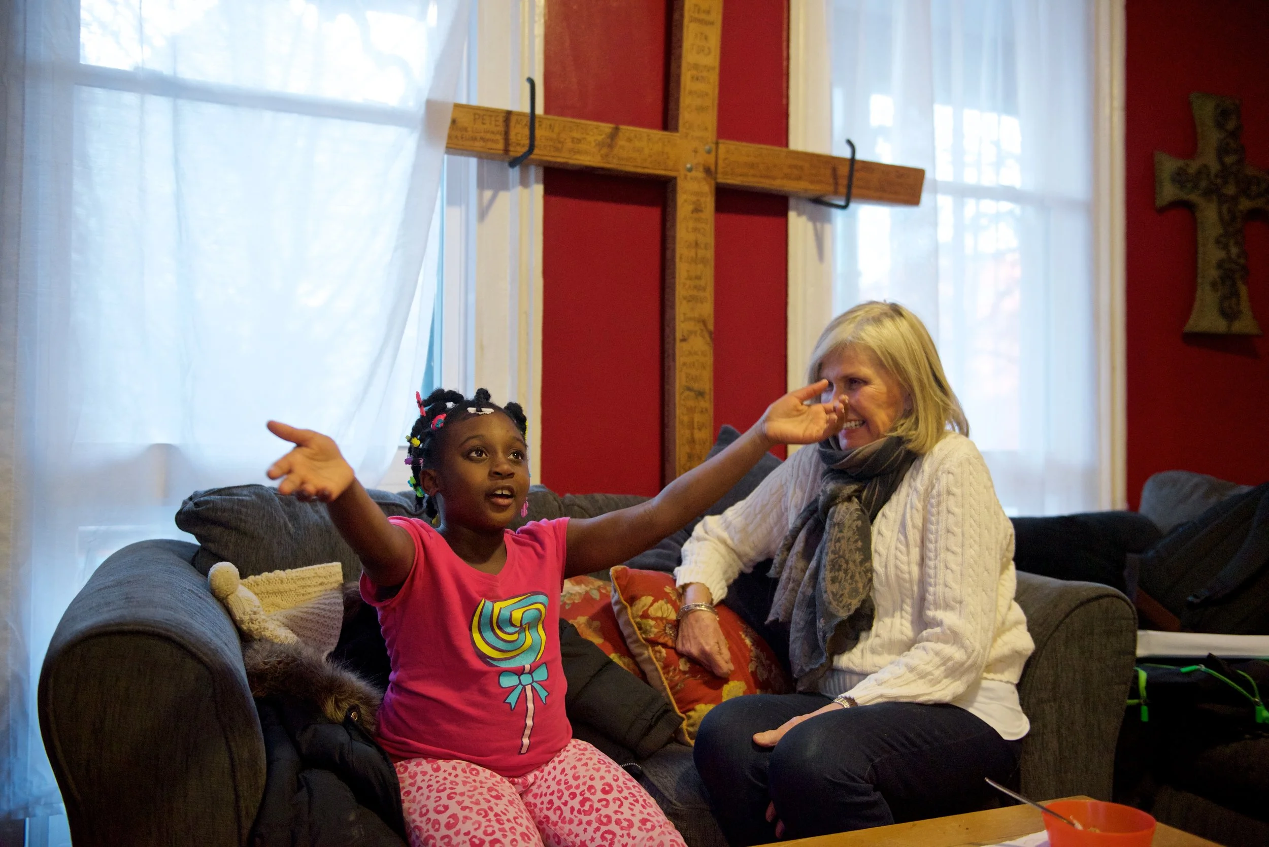 A young girl tells her mentor a story in an after school program at Hartford Catholic Workers.