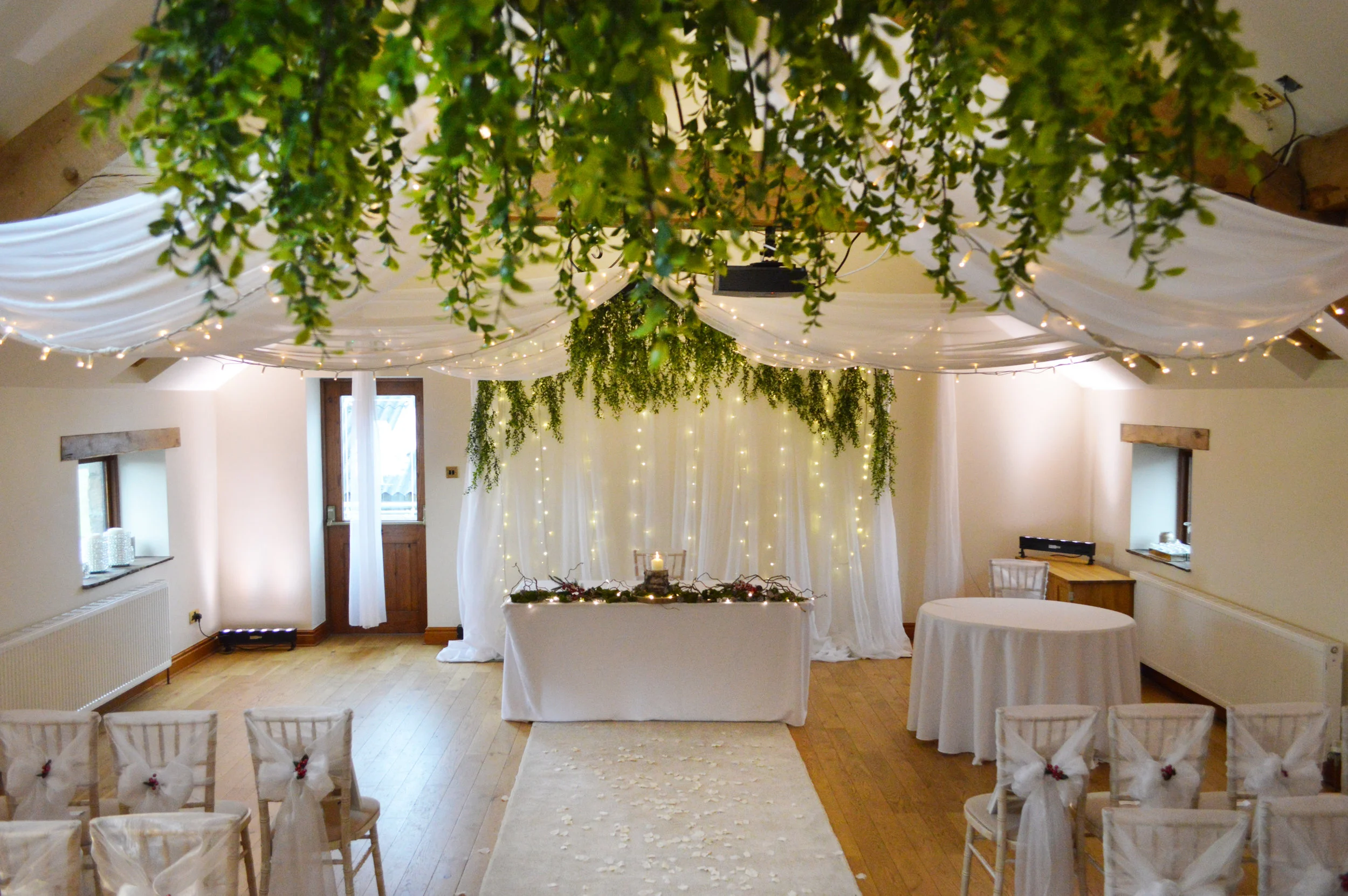 Greenery on chandelier and fairy light backdrop