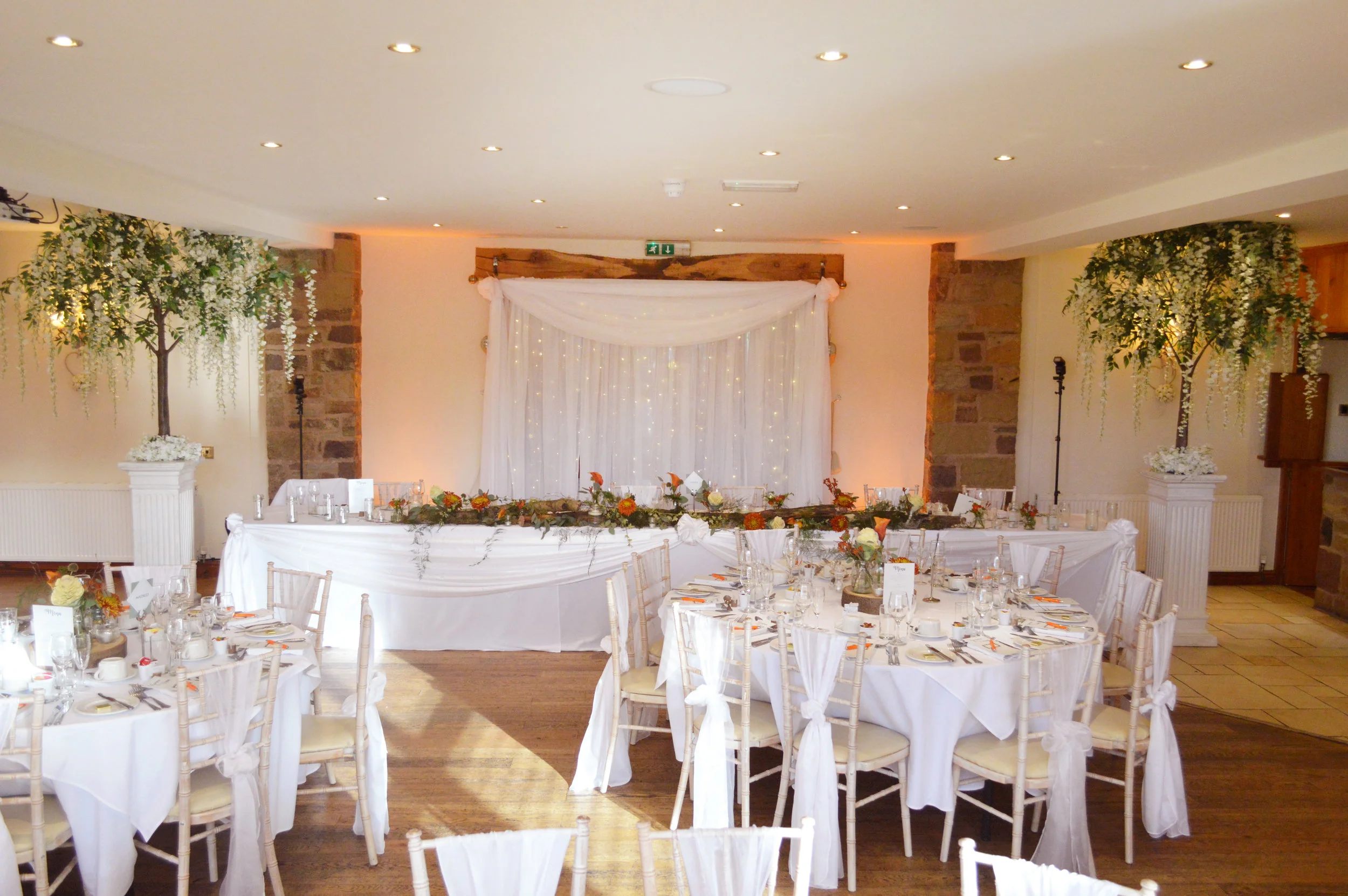 Wisteria trees next to the top table and top table drape