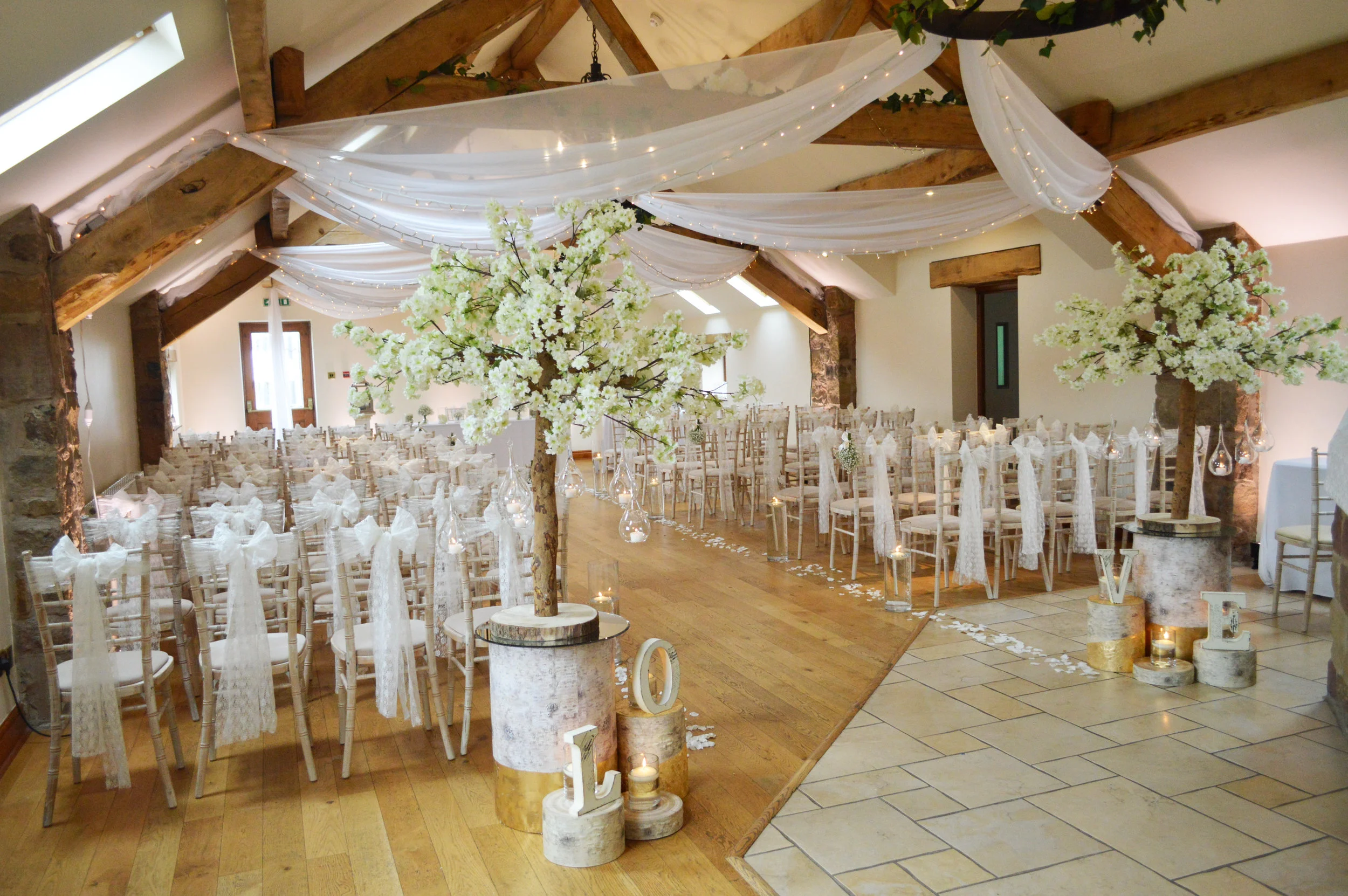 'LOVE' with blossom trees, logs and candles