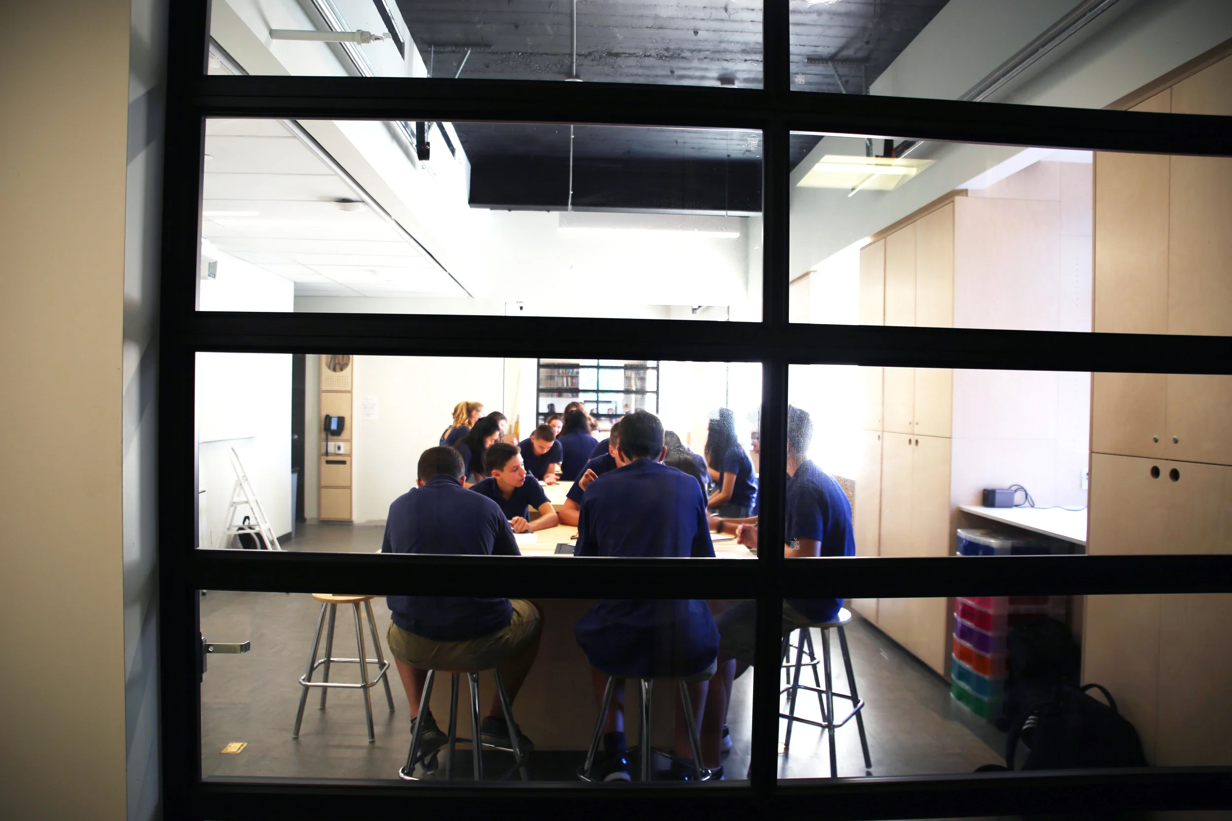 Students seen from behind one of the 'garage doors' which make the Schad Design/Tech Lab an even more flexible space, depending on activity and class size.