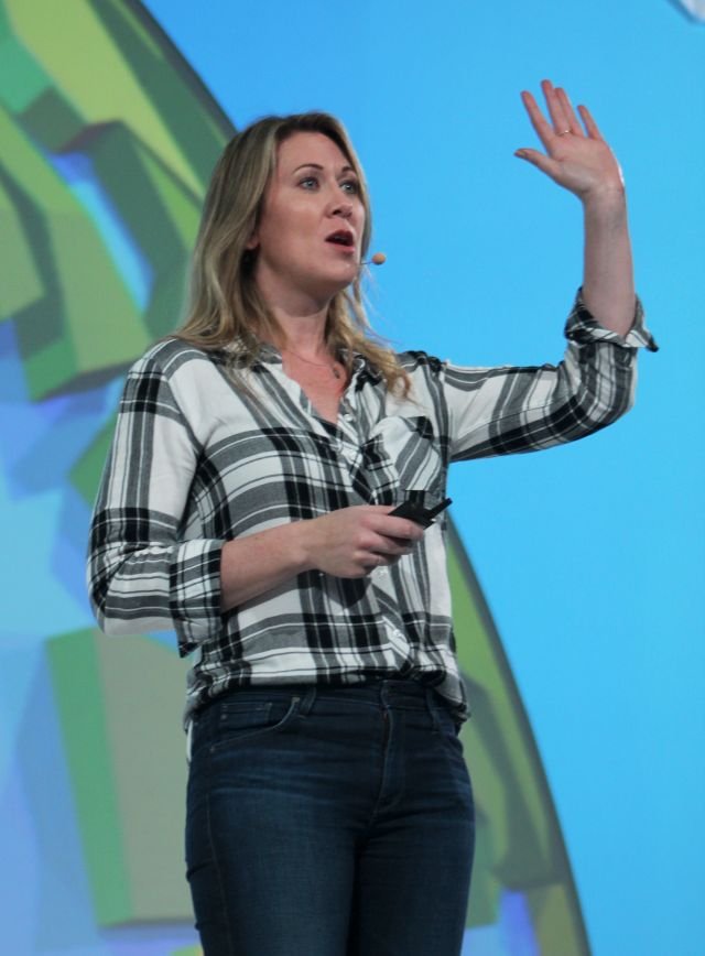 Nicole Forsgren giving a speaking presentation. She is holding one hand up while addressing the crowd