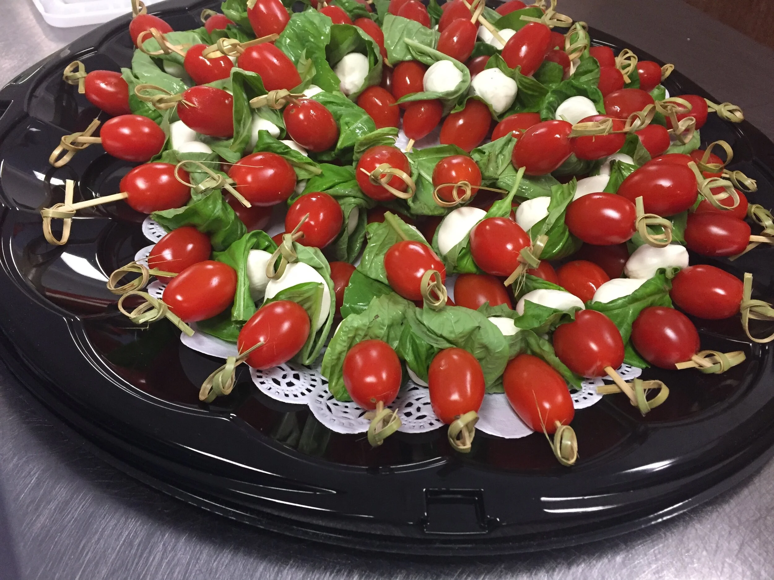 Platter of mozzarella with tomatoes and basil
